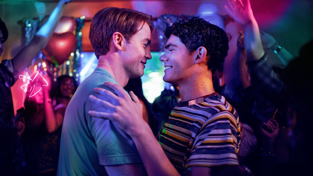 Nick et Charlie enlaces et souriants sur la piste de danse dans Heartstopper Forever